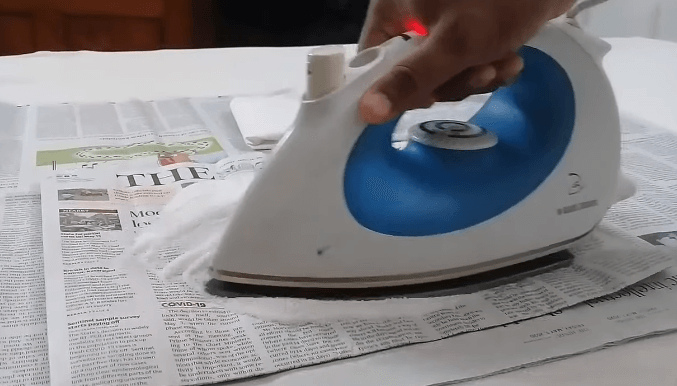 Moving iron on salt to remove stains from soleplate